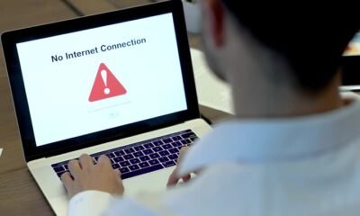 Businessman looking at an internet failure screen on a computer. He is in an office
