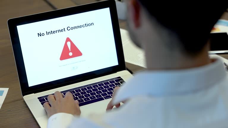 Businessman looking at an internet failure screen on a computer. He is in an office