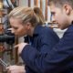 Female Trainee Plumber Working On Central Heating Boiler